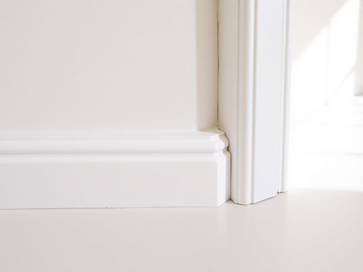 Gap at the junction of a skirting board and architrave